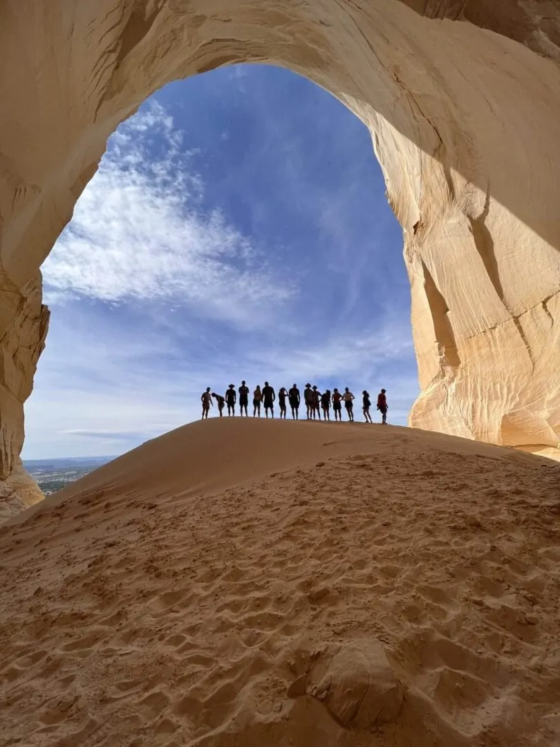 A Coral Cliffs tour group on top of the sand dune at the Great Chamber