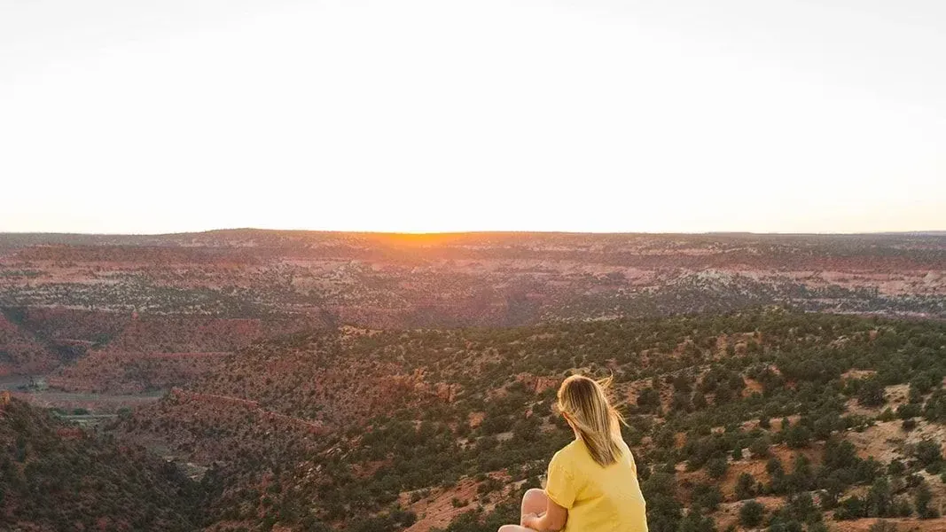 A guest watching the sun set over the canyons and plateaus near Kanab
